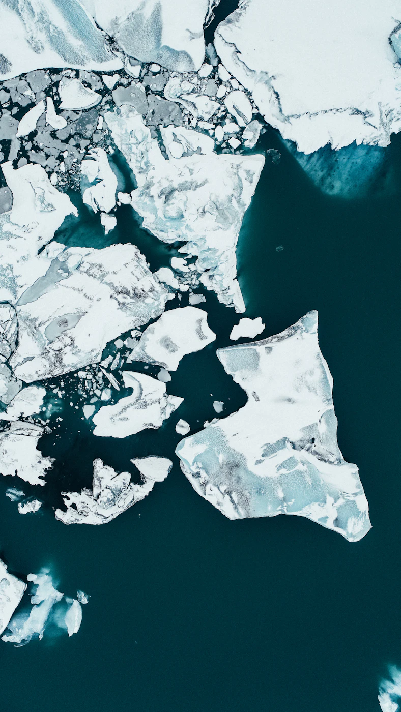 Broken ice on dark water seen from above
