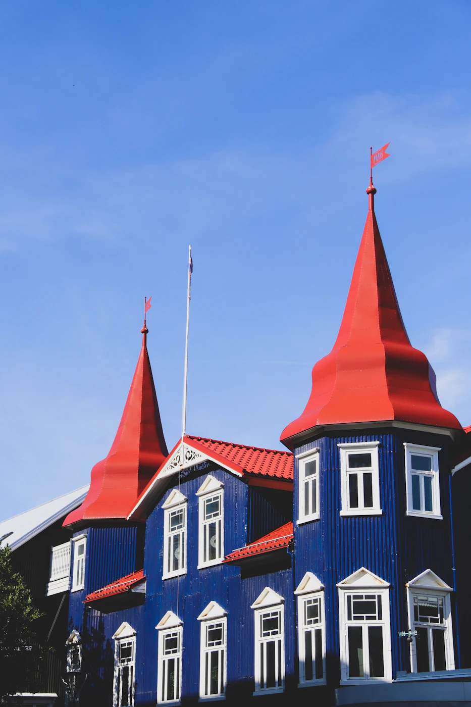 A blue house with bright red turrets