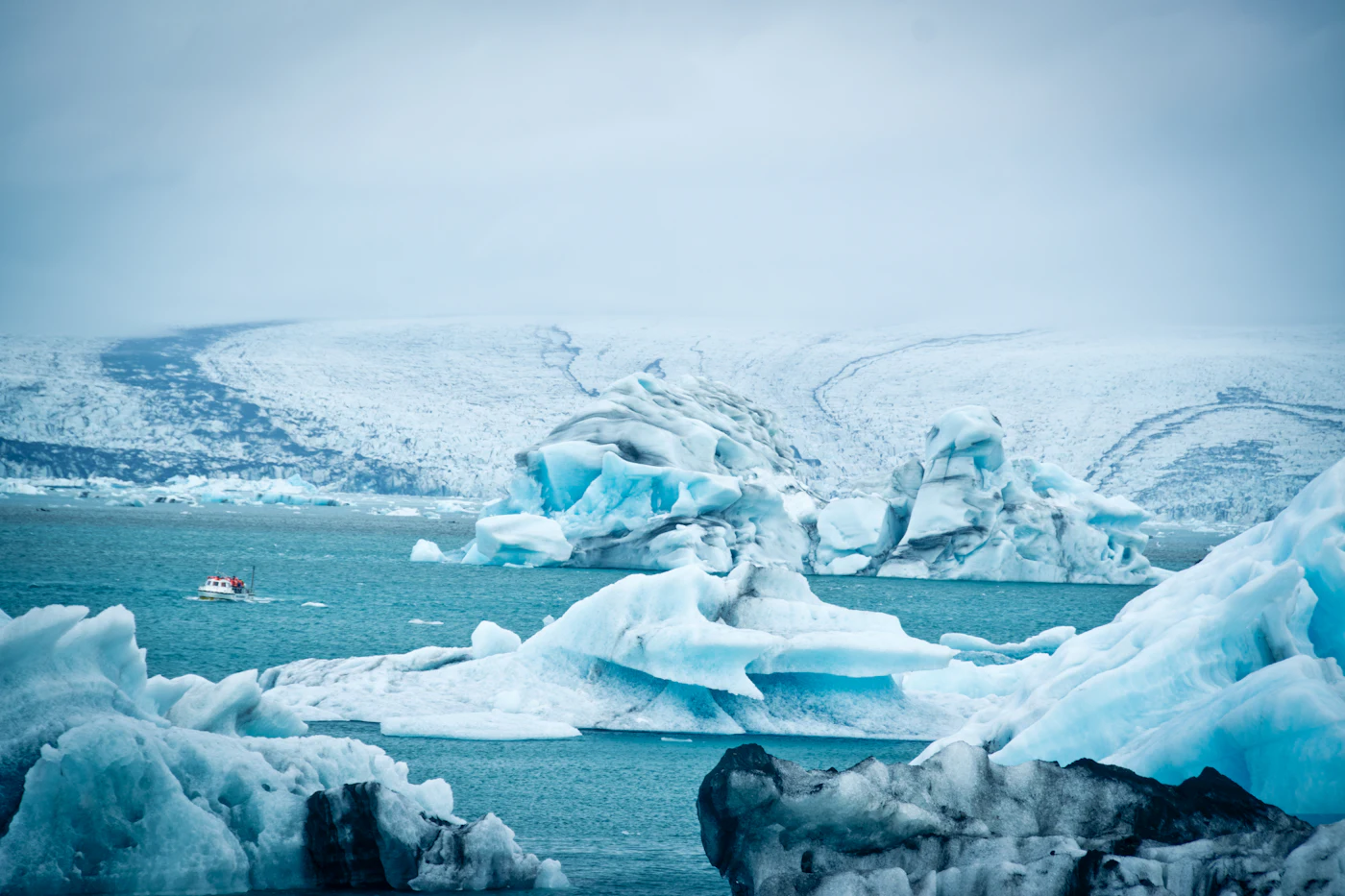 Blue icebergs crowding Jökulsárlón below the glacier