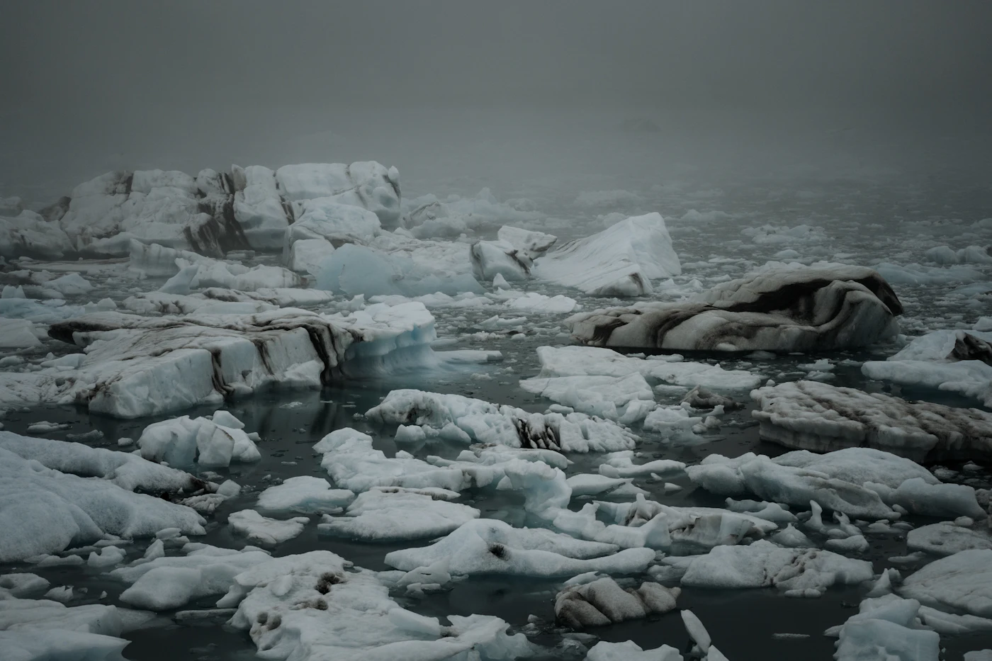 Grey ice floes under a heavy evening sky
