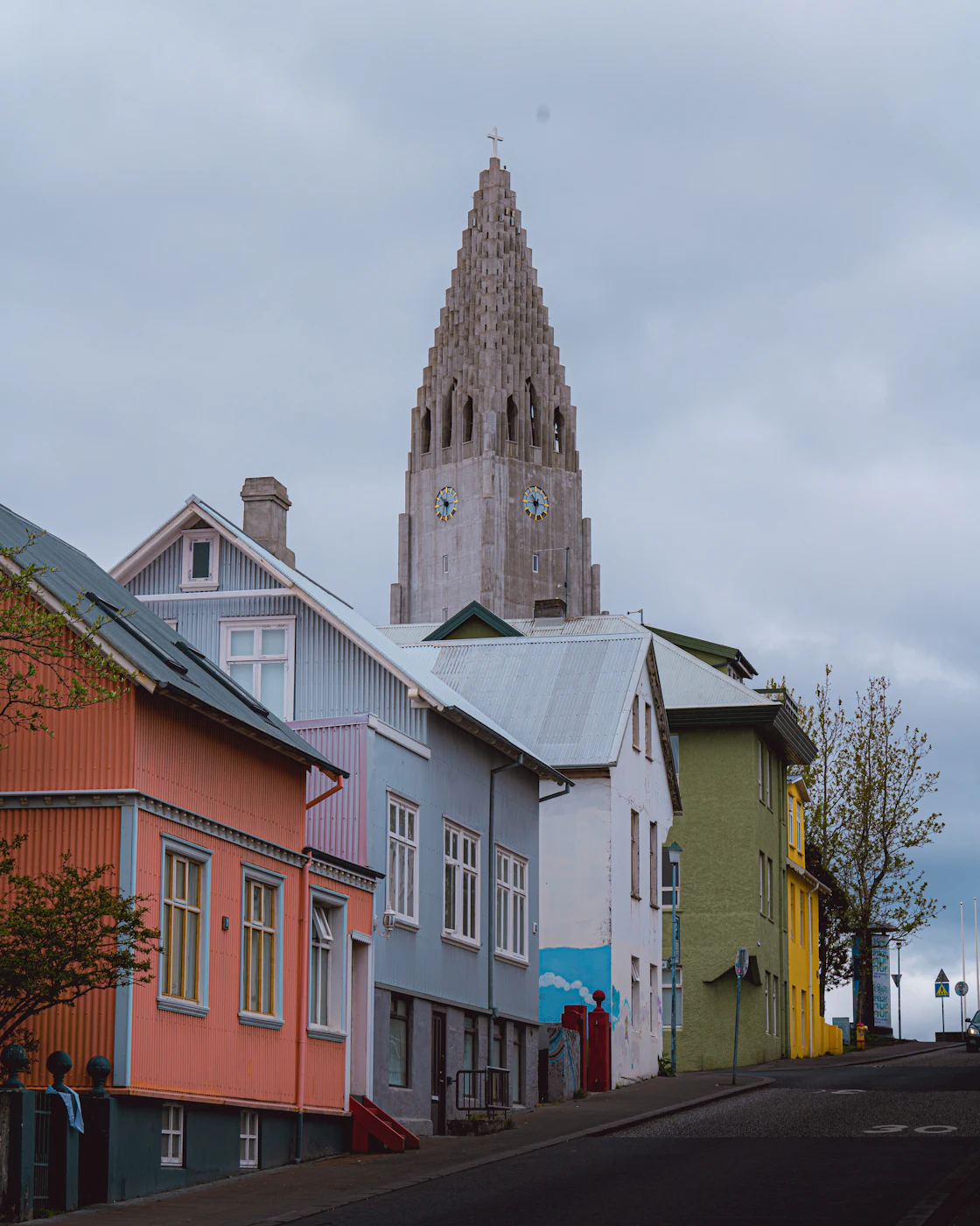 Painted wooden houses with the church steeple behind them